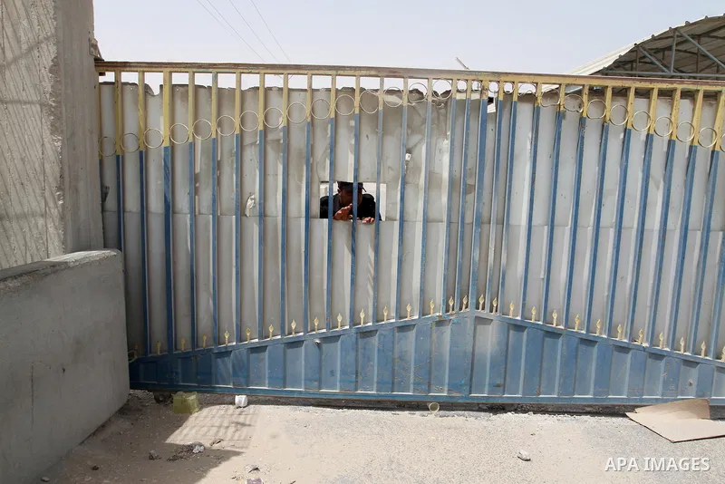 A Palestinian security officer looks out of a gate on the Palestinian side of the Kerem Shalom crossing between Israel and the southern Gaza Strip, south of Rafah, on June 7, 2015 after Israel closed, until further notic...