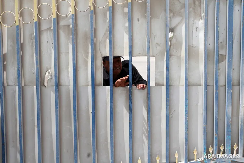A Palestinian security officer looks out of a gate on the Palestinian side of the Kerem Shalom crossing between Israel and the southern Gaza Strip, south of Rafah, on June 7, 2015 after Israel closed, until further notic...
