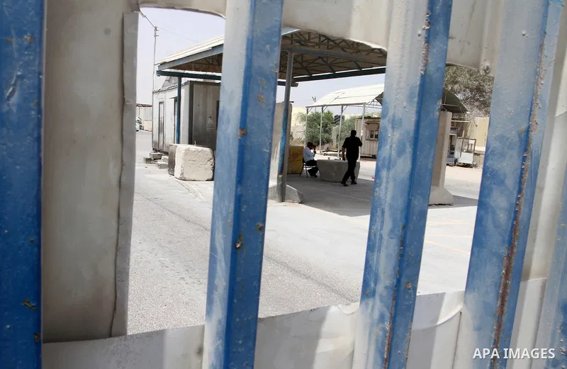 A Palestinian security officer walks past the gate under Palestinian control at the Kerem Shalom crossing between Israel and the southern Gaza Strip, south of Rafah on June 7, 2015 after Israel closed, until further noti...