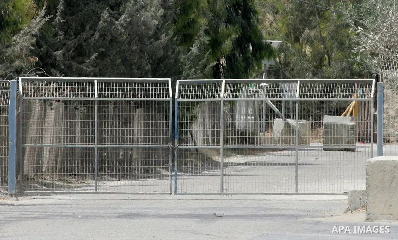 A Palestinian security officer closes the gate under Palestinian control at the Kerem Shalom crossing between Israel and the southern Gaza Strip, south of Rafah on June 7, 2015 after Israel closed, until further notice,...