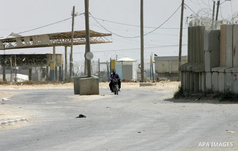 A Palestinian man rides a motorcycle near the gate under Palestinian control at the Kerem Shalom crossing between Israel and the southern Gaza Strip, south of Rafah on June 7, 2015 after Israel closed, until further noti...