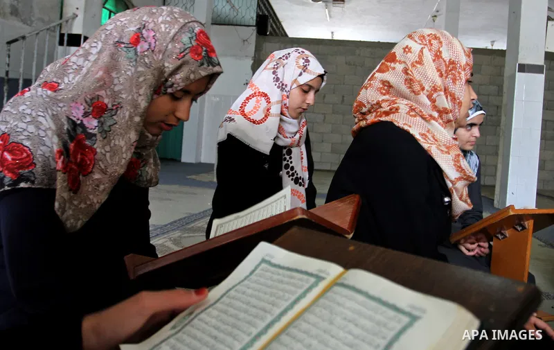 Palestinian girls attend a Quran lesson at a Hamas-sponsored summer program, during summer vacation at a mosque in Rafah, southern Gaza Strip, on June 7, 2015. The Quran memorisation program is one of the latest activiti...