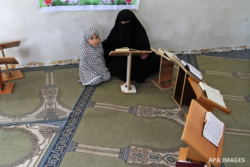 Palestinian girls attend a Quran lesson at a Hamas-sponsored summer program, during summer vacation at a mosque in Rafah, southern Gaza Strip, on June 7, 2015. The Quran memorisation program is one of the latest activiti...