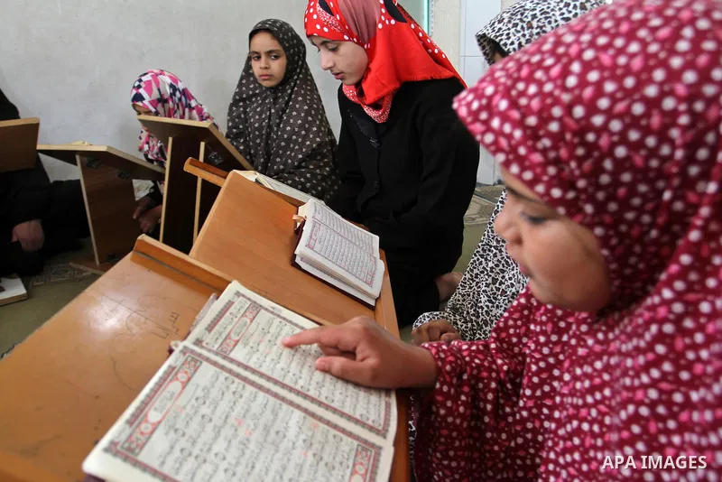Palestinian girls attend a Quran lesson at a Hamas-sponsored summer program, during summer vacation at a mosque in Rafah, southern Gaza Strip, on June 7, 2015. The Quran memorisation program is one of the latest activiti...