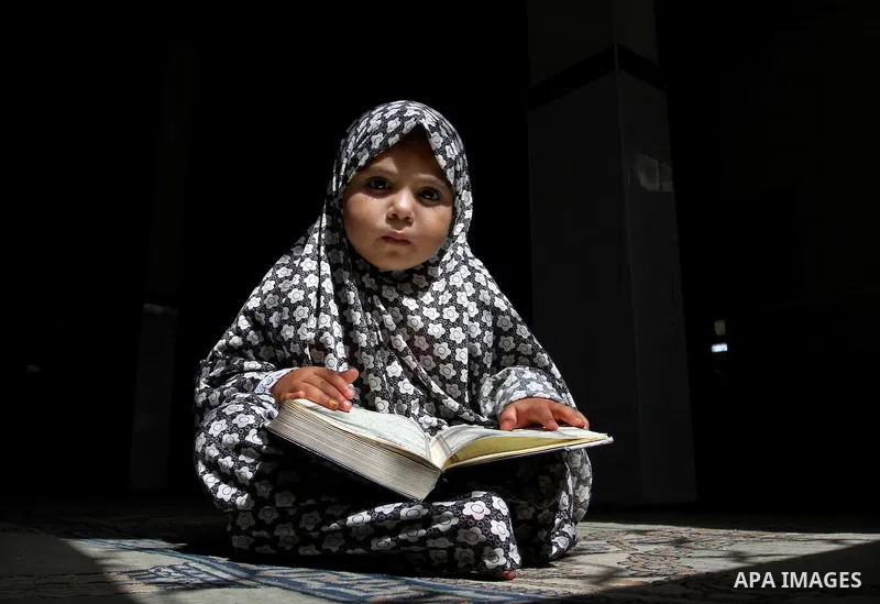 A Palestinian girl attends a Quran lesson at a Hamas-sponsored summer program, during summer vacation at a mosque in Rafah, southern Gaza Strip, on June 7, 2015. The Quran memorisation program is one of the latest activi...