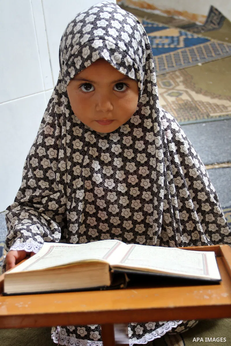A Palestinian girl attends a Quran lesson at a Hamas-sponsored summer program, during summer vacation at a mosque in Rafah, southern Gaza Strip, on June 7, 2015. The Quran memorisation program is one of the latest activi...