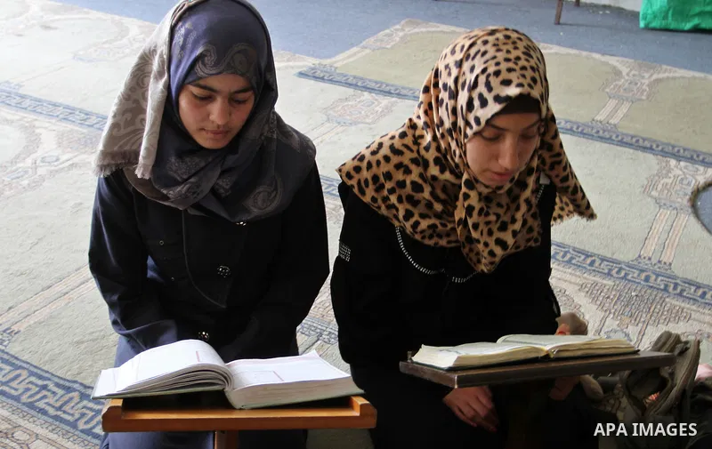 Palestinian girls attend a Quran lesson at a Hamas-sponsored summer program, during summer vacation at a mosque in Rafah, southern Gaza Strip, on June 7, 2015. The Quran memorisation program is one of the latest activiti...