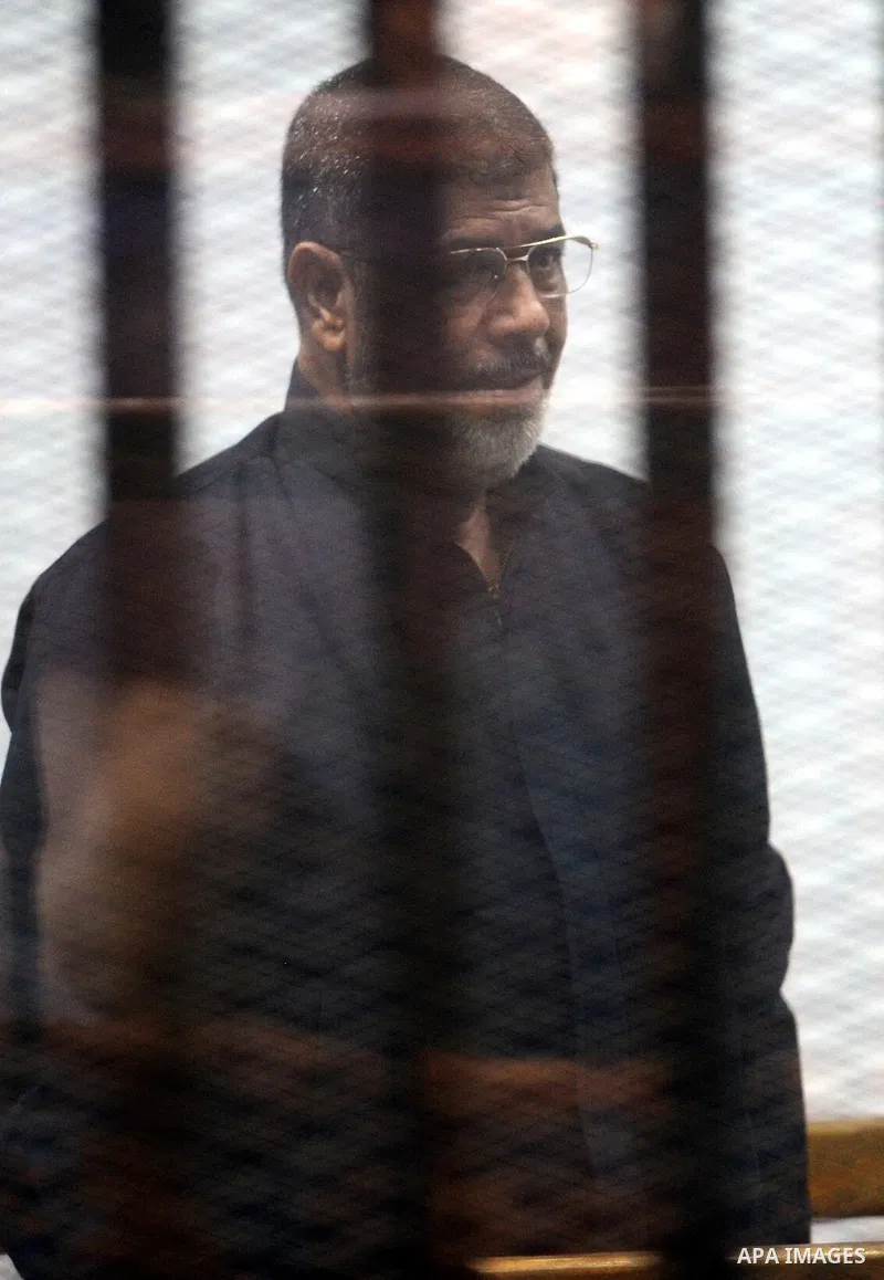 Former Egyptian president Mohamed Morsi stands at a defendants cage as he attends his trial at Cairo criminal court on June 7, 2015. Cairo criminal court considers today, Sunday a new session of the trial of deposed pres...