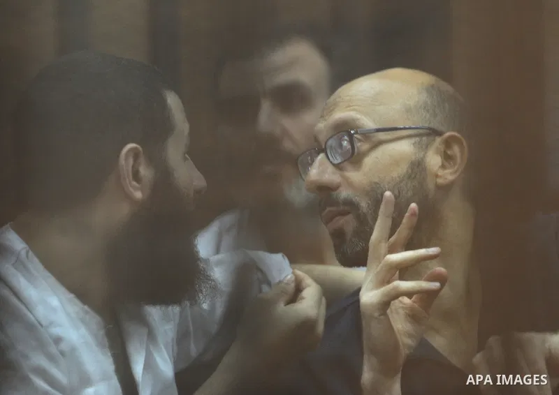 Egyptian Muslim Brotherhood Members sit at defendants cage as they attend their trial along with former president Mohamed Morsi at Cairo criminal court on June 7, 2015. Cairo criminal court considers today, Sunday a new...