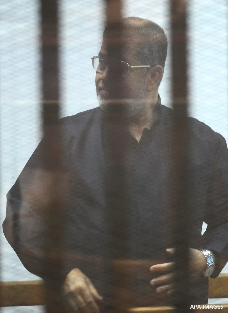 Former Egyptian president Mohamed Morsi stands at a defendants cage as he attends his trial at Cairo criminal court on June 7, 2015. Cairo criminal court considers today, Sunday a new session of the trial of deposed pres...