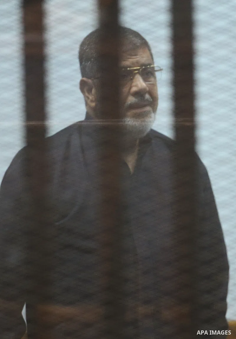 Former Egyptian president Mohamed Morsi stands at a defendants cage as he attends his trial at Cairo criminal court on June 7, 2015. Cairo criminal court considers today, Sunday a new session of the trial of deposed pres...
