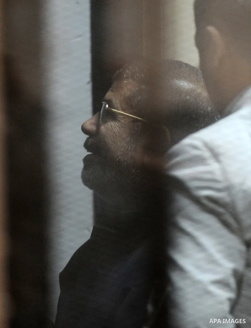 Former Egyptian president Mohamed Morsi stands at a defendants cage as he attends his trial at Cairo criminal court on June 7, 2015. Cairo criminal court considers today, Sunday a new session of the trial of deposed pres...