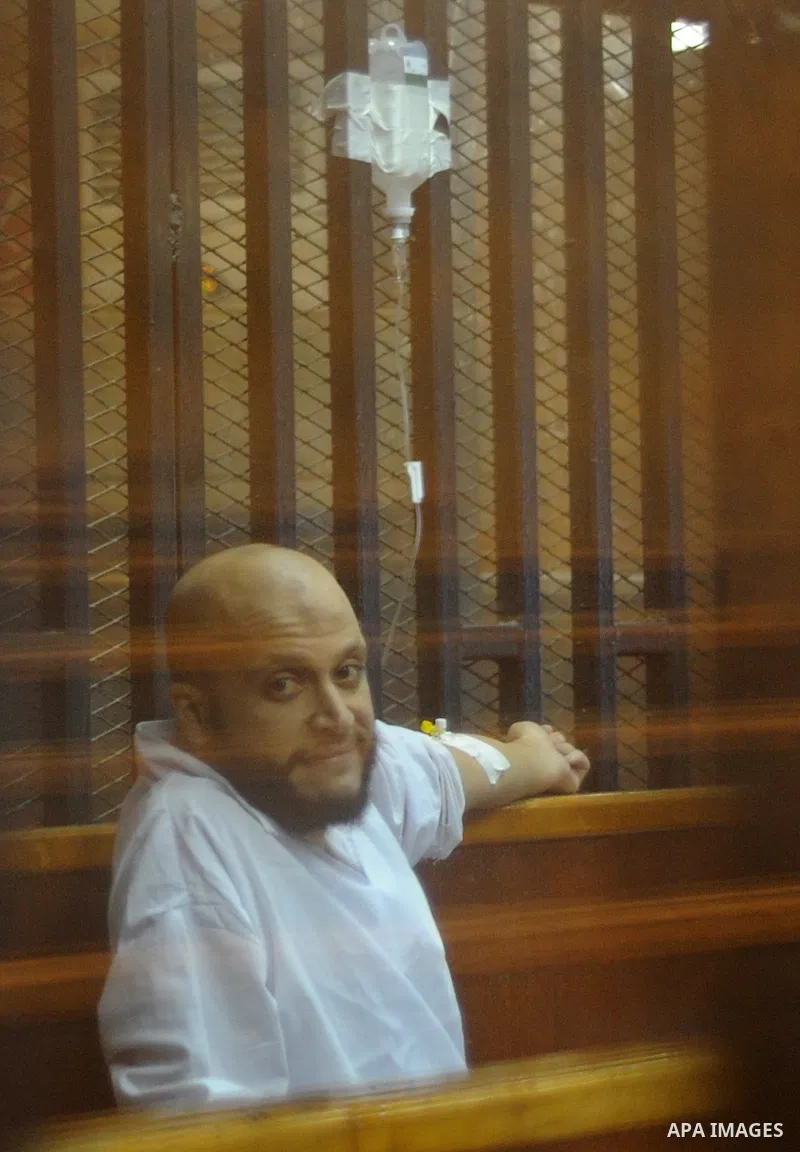 Egyptian Muslim Brotherhood Members sit at defendants cage as they attend their trial along with former president Mohamed Morsi at Cairo criminal court on June 7, 2015. Cairo criminal court considers today, Sunday a new...