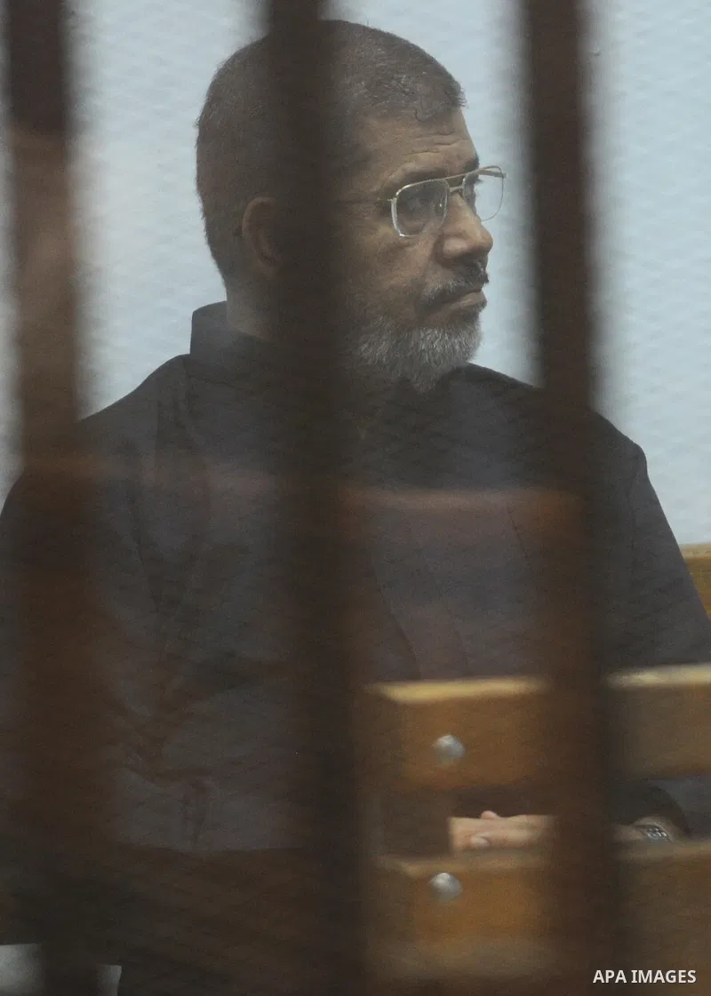 Former Egyptian president Mohamed Morsi stands at a defendants cage as he attends his trial at Cairo criminal court on June 7, 2015. Cairo criminal court considers today, Sunday a new session of the trial of deposed pres...