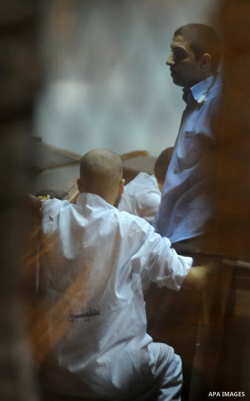 Egyptian Muslim Brotherhood Members sit at defendants cage as they attend their trial along with former president Mohamed Morsi at Cairo criminal court on June 7, 2015. Cairo criminal court considers today, Sunday a new...