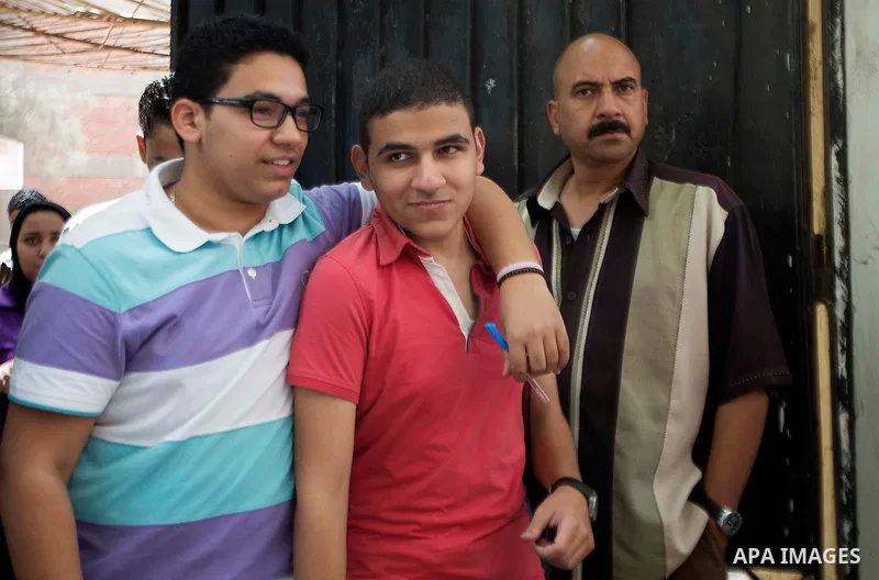 Egyptian students walk outside their school following the final high school exams known as ''Tawjihi'', in Cairo on June 7, 2015. The nationwide Arabic exam of Egypt's general secondary certificate was leaked online Sund...