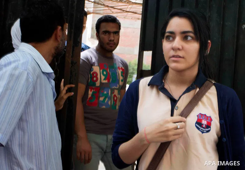 Egyptian students walk outside their school following the final high school exams known as ''Tawjihi'', in Cairo on June 7, 2015. The nationwide Arabic exam of Egypt's general secondary certificate was leaked online Sund...