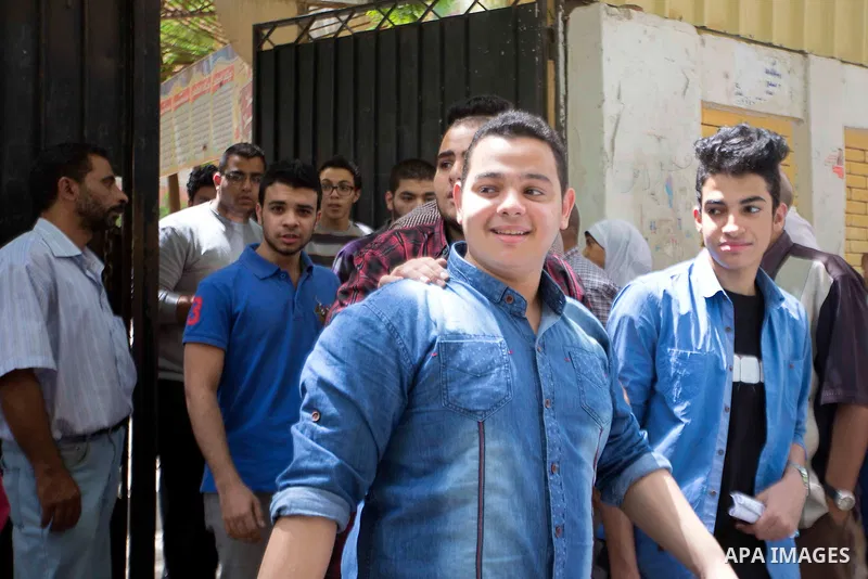 Egyptian students walk outside their school following the final high school exams known as ''Tawjihi'', in Cairo on June 7, 2015. The nationwide Arabic exam of Egypt's general secondary certificate was leaked online Sund...
