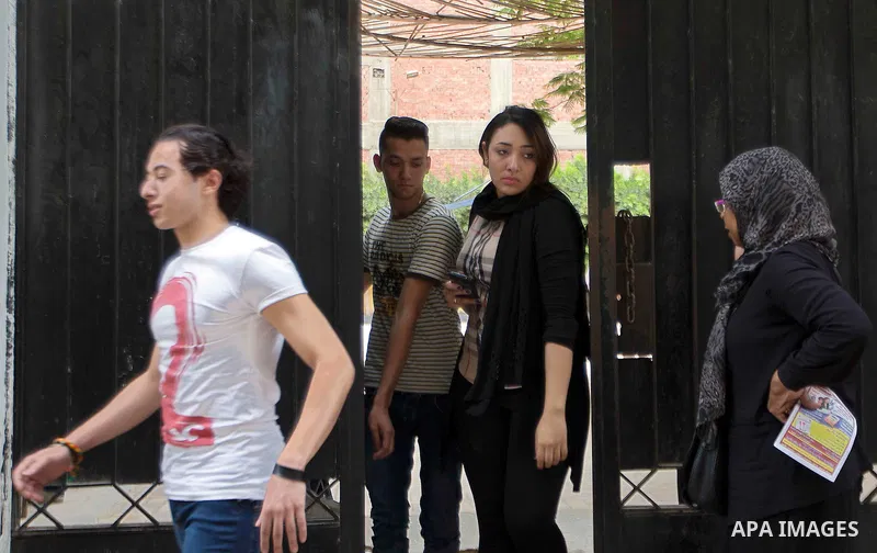 Egyptian students walk outside their school following the final high school exams known as ''Tawjihi'', in Cairo on June 7, 2015. The nationwide Arabic exam of Egypt's general secondary certificate was leaked online Sund...