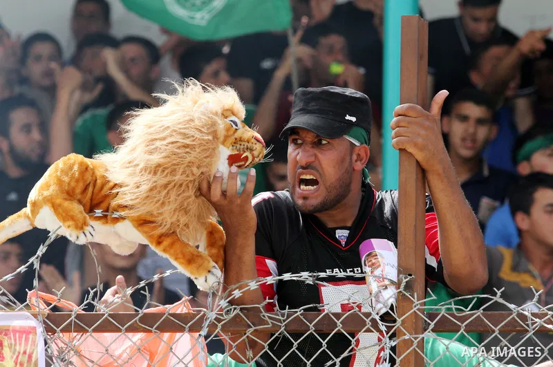 Palestinian fans chant and cheer during the final match between al-Shijaiyah club and Rafah club in a local championship, at al-Yarmouk stadium in Gaza city on June 7, 2015. Photo by Mohammed al-Dallow