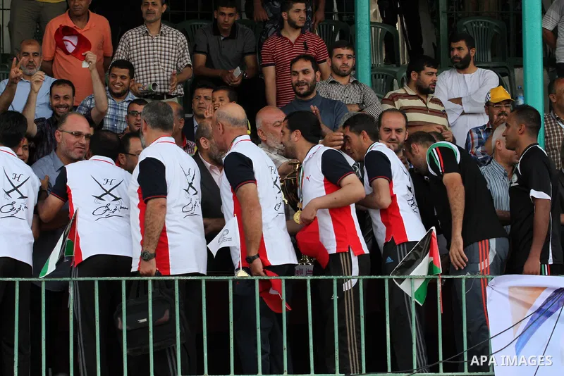 Players of al-Shijaiyah club raise the championship trophy after winning the final match against Rafah club in a local championship, at al-Yarmouk stadium in Gaza city on June 7, 2015. Photo by Mohammed al-Dallow