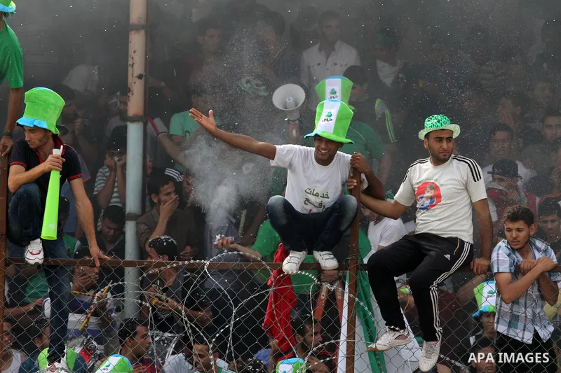 Palestinian fans chant and cheer during the final match between al-Shijaiyah club and Rafah club in a local championship, at al-Yarmouk stadium in Gaza city on June 7, 2015. Photo by Mohammed al-Dallow