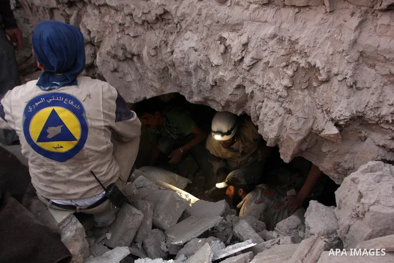 Rescue workers search under the debris of a building following a reported bomb barrel attack by Syrian government forces, in al-Maadi district in the northern Syrian city of Aleppo, June 7, 2015. At least a civilian was...