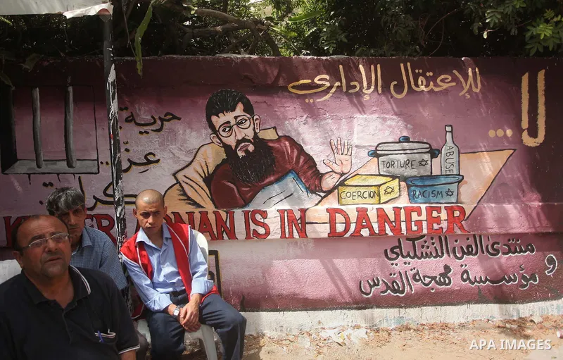 Palestinians take part in a protest demanding release the prisoners in Israeli jails, in front of Red cross office, in Gaza city, on June 8, 2015. Photo by Ashraf Amra