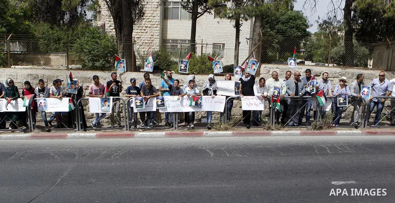 Palestinians hold placards during a demonstration in support of the family of Mohammed Abu Khder, a Palestinian teenager who was kidnapped from east Jerusalem on July 2,2014 and burned to death by Jewish extremists in a...