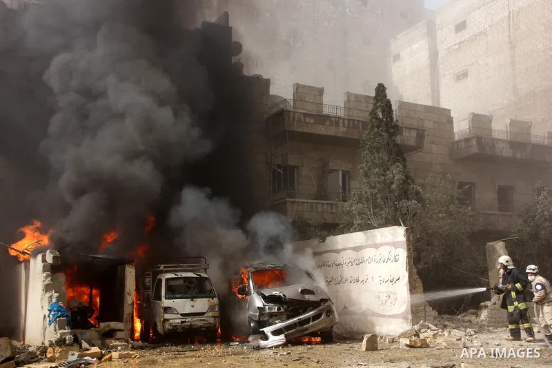 Syrian firefighters try to extinguish the fire in the burning buses in a reported barrel bomb attack by Syrian government forces, at al-Ansari district in the northern Syrian city of Aleppo, June 9, 2015. At least a civi...
