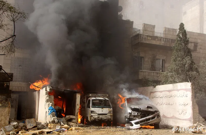 Syrian firefighters try to extinguish the fire in the burning buses in a reported barrel bomb attack by Syrian government forces, at al-Ansari district in the northern Syrian city of Aleppo, June 9, 2015. At least a civi...