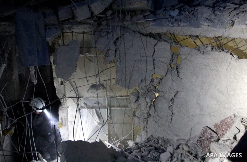 Syrian civil defense members search for the victims after a reported barrel bomb attack by Syrian government forces at al-mayser district in the northern Syrian city of Aleppo, June 8, 2015. Photo by Ameer al-Halbi