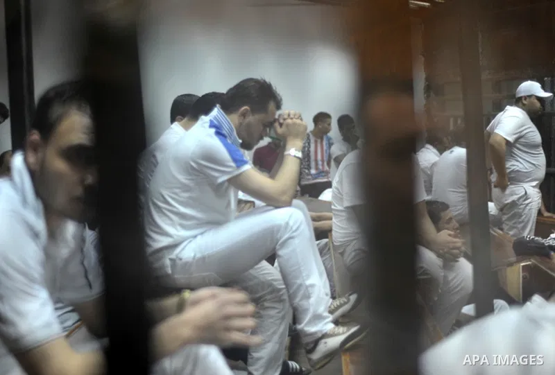Egyptian defendants sit behind bars after the verdict in their retrial over a 2012 stadium riot in the canal city of Port Said that left 74 people dead, in a court in the Egyptian capital, Cairo on June 9, 2015. The cour...