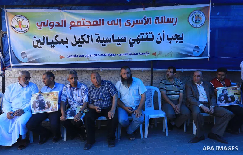 Palestinian protesters take part in a protest in support of Palestinian Khader Adnan, a senior member of Islamic Jihad who is jailed in Israel without a trial, in Gaza city, June 10, 2015. Photo by Mohammed Asad