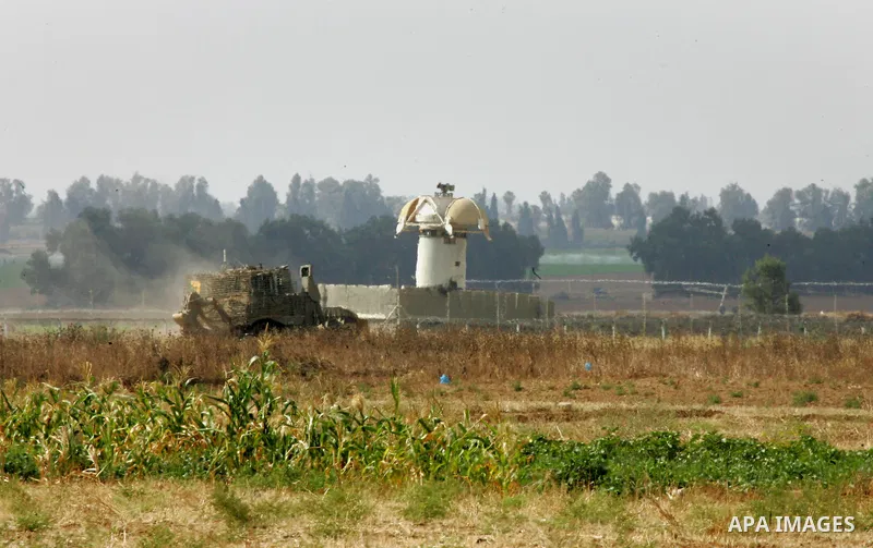 Israeli bulldozers work along a barbed wire fence that separates Khan Yunis in the southern Gaza Strip and the Israeli border, on June 10, 2015. Israel is to reopen border crossings to and from the Gaza Strip the coming...