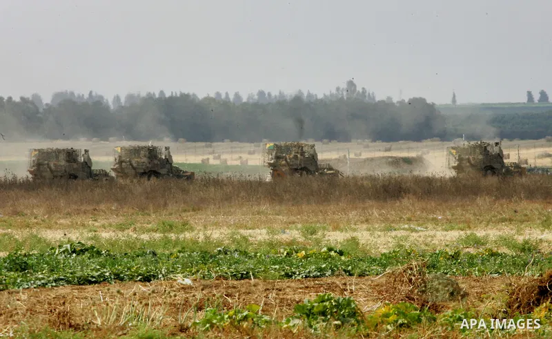 Israeli bulldozers work along a barbed wire fence that separates Khan Yunis in the southern Gaza Strip and the Israeli border, on June 10, 2015. Israel is to reopen border crossings to and from the Gaza Strip the coming...