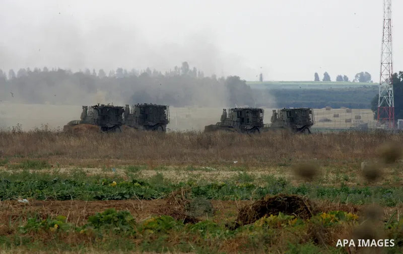 Israeli bulldozers work along a barbed wire fence that separates Khan Yunis in the southern Gaza Strip and the Israeli border, on June 10, 2015. Israel is to reopen border crossings to and from the Gaza Strip the coming...