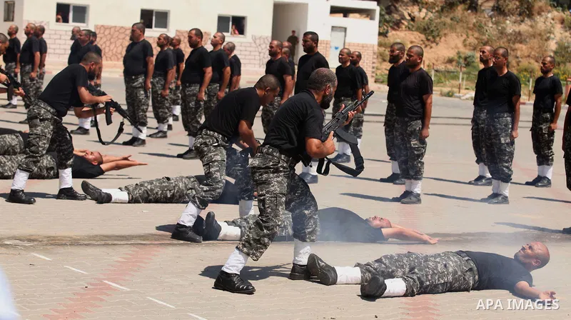 Members of Palestinian national security forces demonstrate their skills during a military graduation ceremony in the northern Gaza Strip, June 11, 2015. Photo by Ashraf Amra