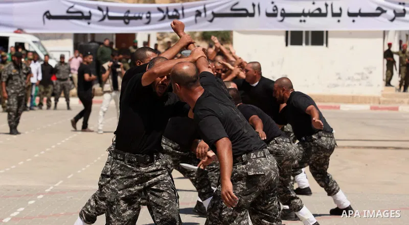 Members of Palestinian national security forces demonstrate their skills during a military graduation ceremony in the northern Gaza Strip, June 11, 2015. Photo by Ashraf Amra