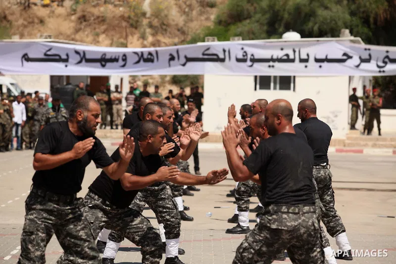 Members of Palestinian national security forces demonstrate their skills during a military graduation ceremony in the northern Gaza Strip, June 11, 2015. Photo by Ashraf Amra