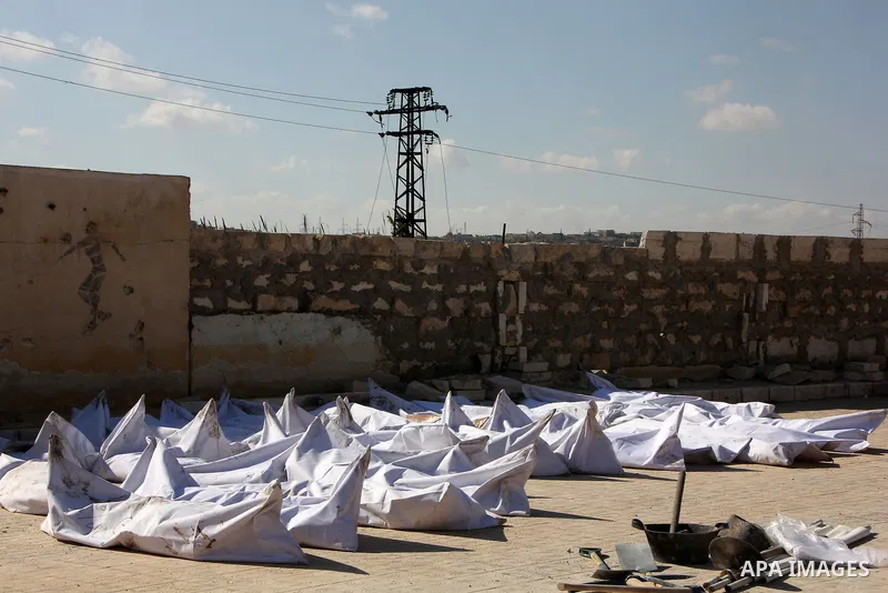 The bodies of dead fighters loyal to Syrian President Bashar al-Assad are seen during an exchange of dead bodies between Free Syrian Army and Syrian Government forces, in Bustan al-Qasr district in the east of the northe...