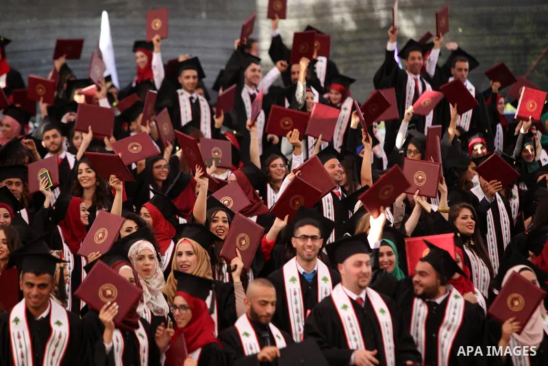 Palestinian students attend their graduation ceremony at the Birzeit University near the West Bank city of Ramallah, June 12, 2015. Photo by Shadi Hatem