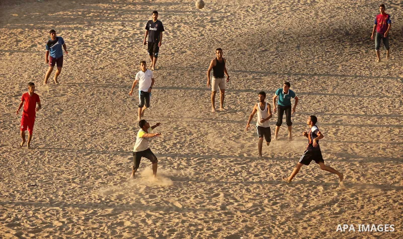 Palestinians enjoy a day at the beach of the Mediterranean Sea on the coast of Gaza City, on June 12, 2015. Photo by Ashraf Amra