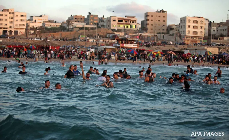 Palestinians enjoy a day at the beach of the Mediterranean Sea on the coast of Gaza City, on June 12, 2015. Photo by Ashraf Amra