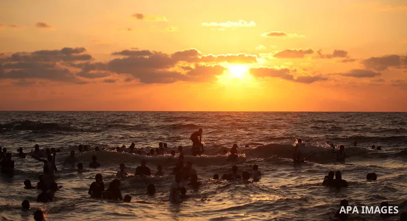 Palestinians enjoy a day at the beach of the Mediterranean Sea on the coast of Gaza City, on June 12, 2015. Photo by Ashraf Amra