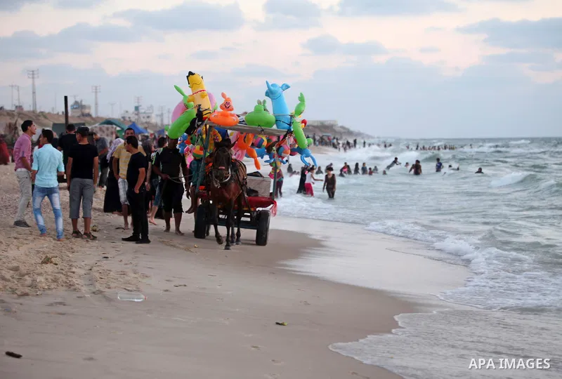 Palestinians enjoy a day at the beach of the Mediterranean Sea on the coast of Gaza City, on June 12, 2015. Photo by Ashraf Amra