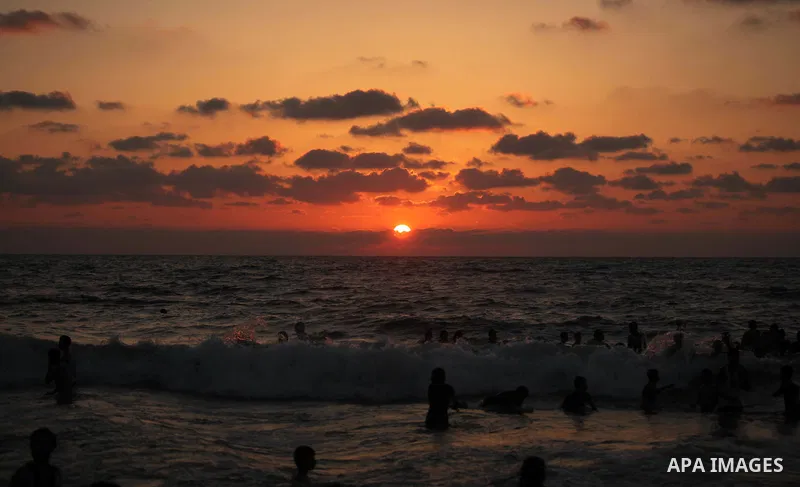 Palestinians enjoy a day at the beach of the Mediterranean Sea on the coast of Gaza City, on June 12, 2015. Photo by Ashraf Amra