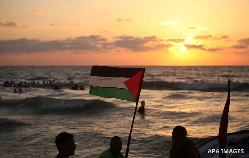 Palestinians enjoy a day at the beach of the Mediterranean Sea on the coast of Gaza City, on June 12, 2015. Photo by Ashraf Amra