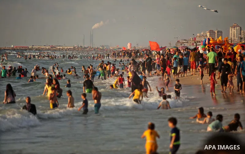 Palestinians enjoy a day at the beach of the Mediterranean Sea on the coast of Gaza City, on June 12, 2015. Photo by Ashraf Amra
