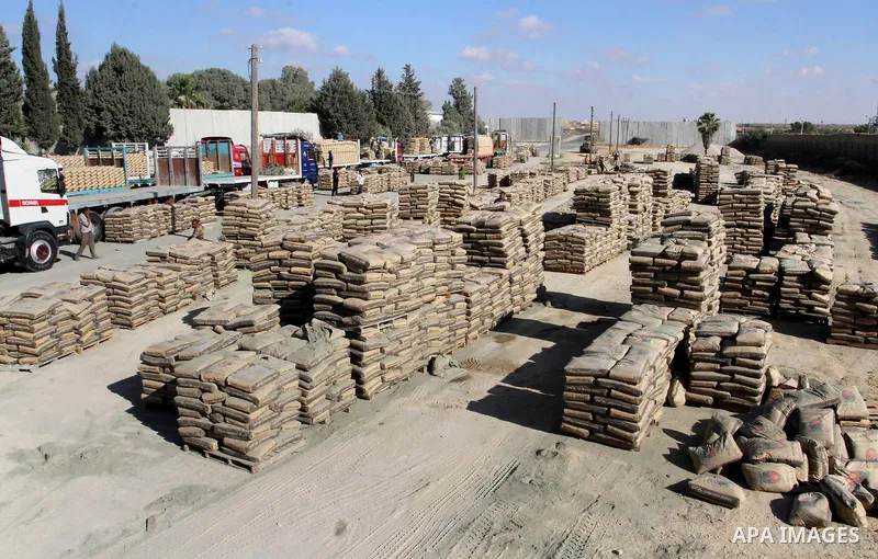 Palestinian workers offload a truck loaded with cement after it entered from Egypt through the Rafah border crossing in southern Gaza Strip, on June 13, 2015. Egyptian authorities for the first time since the expulsion o...